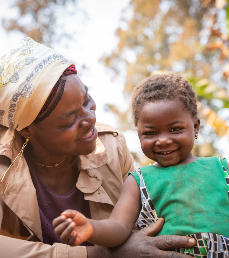 Moment of love and tenderness between African mother and daughter. Smiling toddler african girl with her mother. Mother's day concept